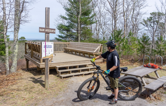 Mountain biker at overlook on Sam Nye Mountain in Maple Swamp Conservation Area